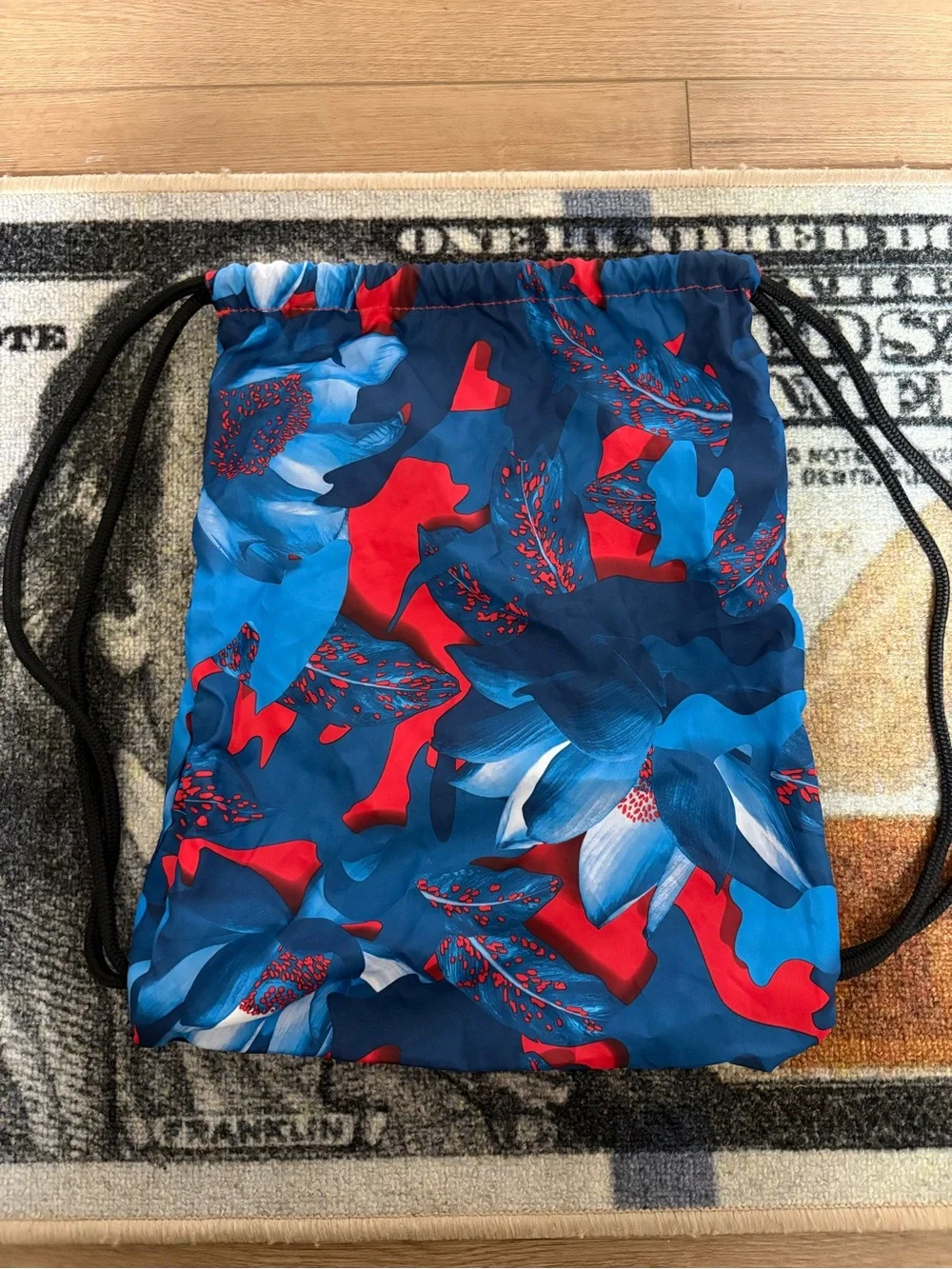 Nike Blue Floral Drawstring Backpack with Light Blue Logo and Red Accents